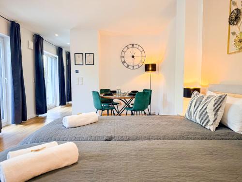 a bedroom with a large bed and a table with chairs at ImmoStay #3 - Penthouse mit zwei Balkonen & Seeblick, Parking & WiFi in Bremen