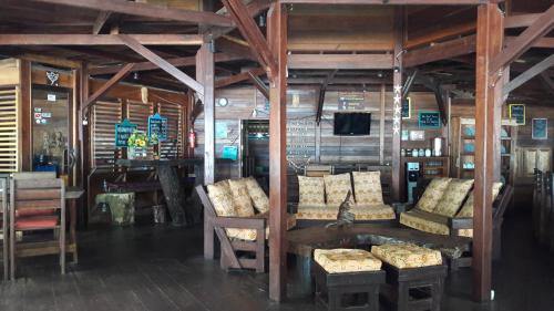 a room with chairs and a table and a tv at Raja Ampat Dive Resort in Tapokreng