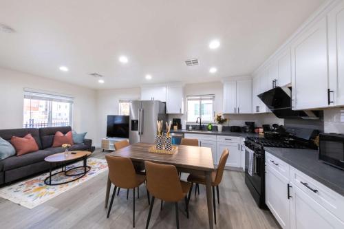 a kitchen and living room with a table and a couch at Modern Private Room in Shared Home -Walk to USC in Los Angeles