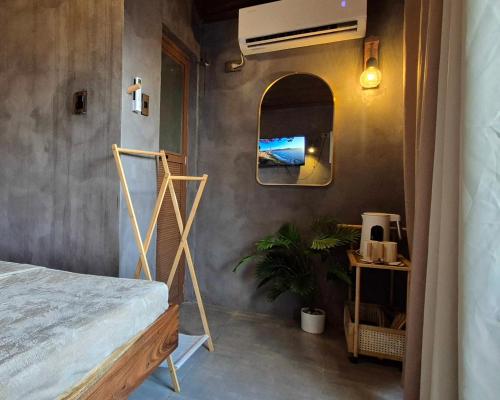 a bedroom with a bed and a mirror at Casa Elia San Juan La Union in San Juan