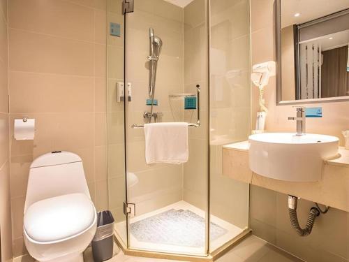 a bathroom with a toilet and a sink at City Comfort Inn Liuzhou Sanjiang Gulou Bird's Nest in Sanjiang