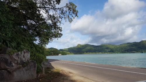 a road next to a body of water at Villa Kayola - Self Catering in Mahe