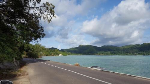an empty road next to a body of water at Villa Kayola - Self Catering in Mahe
