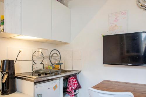 a kitchen with a stove and a counter top at Cosy Studio for 2 in Saint Germain des Pres in Paris