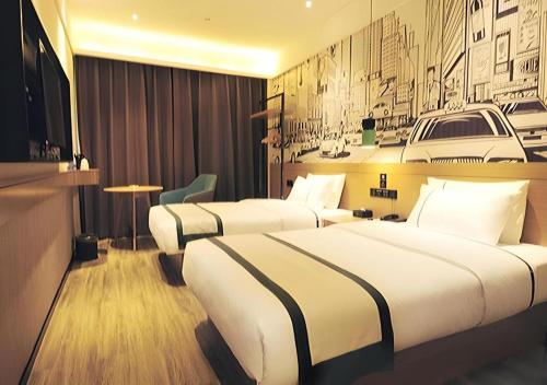 a hotel room with two beds and a wall at City Comfort Inn Suizhou Bingzi Wanda in Suizhou