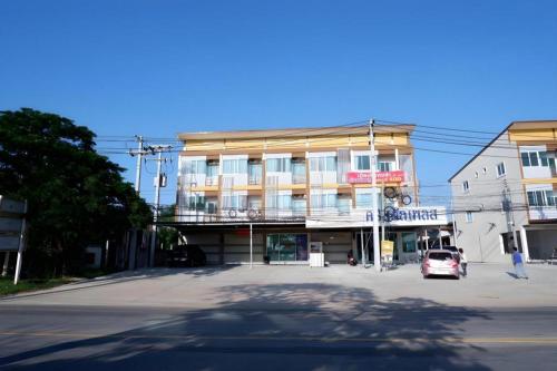 a building with a car parked in front of it at Crystal Place Prathai in Ban Nong Muang