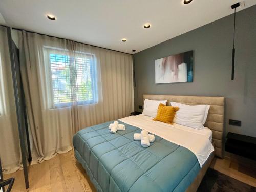 a bedroom with two stuffed animals on a bed at Aparthotel Villa V with breakfast and free parking in Rijeka