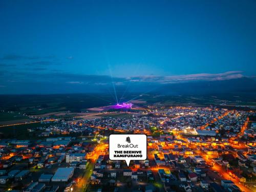 an overhead view of a city at night with a sign at The BEEHIVE KAMIFURANO in Kami-furano