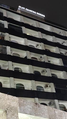 a tall building with a sign on the side of it at Flet do condominio flet 4 rodas in Olinda
