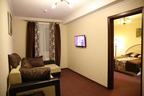 a hotel room with a mirror and a chair and a bed at Argo Premium in Lviv