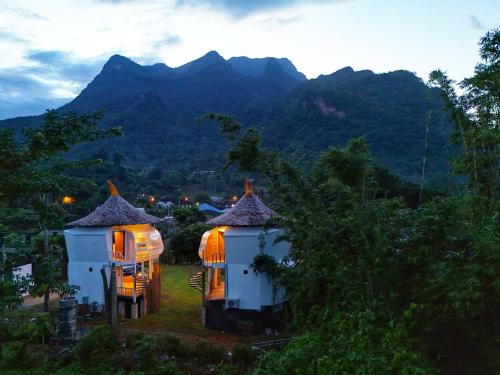 a couple of small houses with lights on them at Wintersong วินเทอร์ซอง เชียงดาว in Chiang Dao