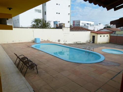 a large blue swimming pool on a patio at Pousada Casarrara in Itaberaba