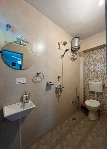 a bathroom with a sink and a toilet and a mirror at Aura B&B - The Haveli Homestay in Jodhpur