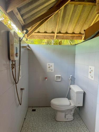 a bathroom with a toilet in a room at Libong Beach Resort in Ko Libong