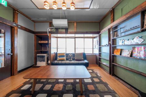 a living room with a couch and a table at TARUNE in Otaru