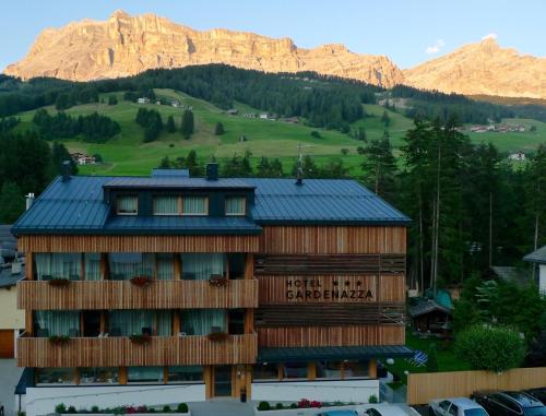 a building with a mountain in the background at Hotel Gardenazza in Badia