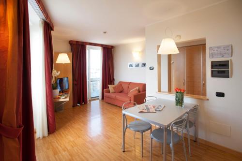a living room with a table and a couch at AlbaResidence Masera26 in Alba