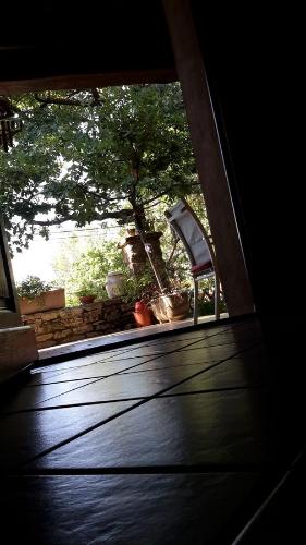 a view of a porch with a chair and a tree at Om'Sleeping B&B in Laudun