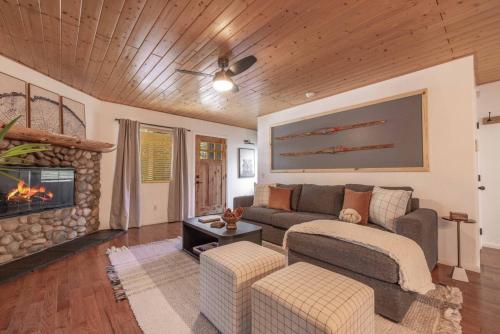 a living room with a couch and a fireplace at Peak Pursuit Jacuzzi, Sauna, Game Room, Renovated in Sugarloaf