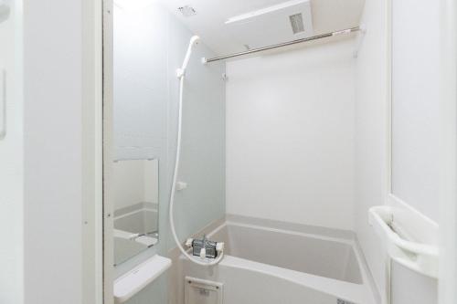 a bathroom with a shower and a sink at VILLA SAKURA Hatanodai II in Tokyo