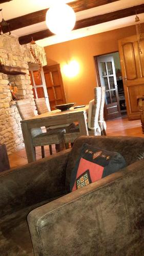 a living room with a couch and a table at Om'Sleeping B&B in Laudun
