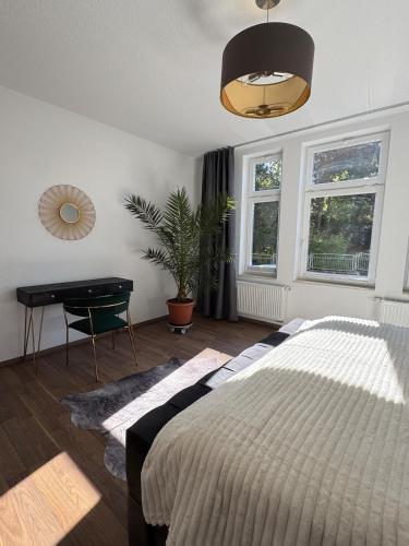 a bedroom with a bed and a desk in it at Apartment Stadtperle in Gotha