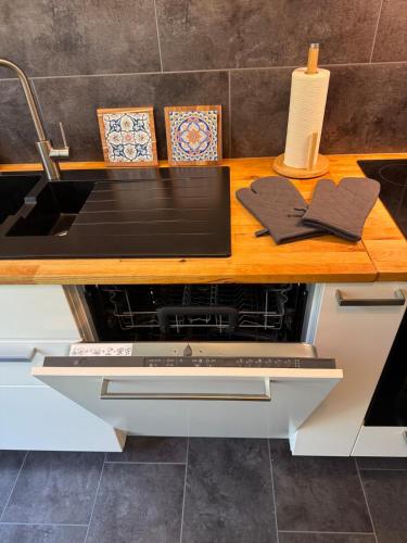 a kitchen counter with a sink and a stove at Apartment Stadtperle in Gotha