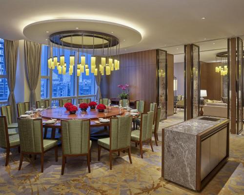 a dining room with a table and chairs at Hyatt Regency Shenzhen Yantian in Shenzhen