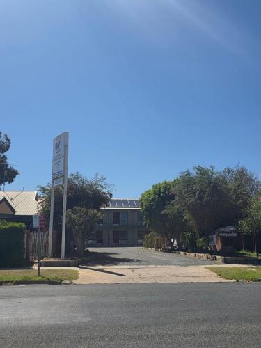 an empty street in front of a building with a speed limit sign at Wentworth Central Motor Inn in Wentworth