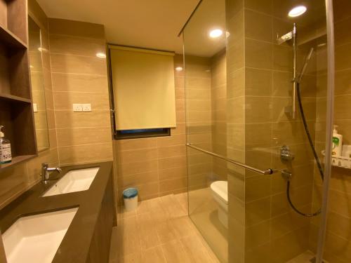 a bathroom with a shower and a toilet and a sink at By The Sea Cozy Beachfront Home 253 in Batu Ferringhi