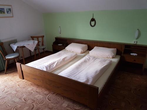 a bedroom with two beds and a table and a table at Griesshof in Neustift im Stubaital