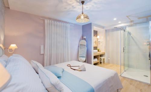 a bedroom with a bed and a glass shower at Villa Boban in Dubrovnik