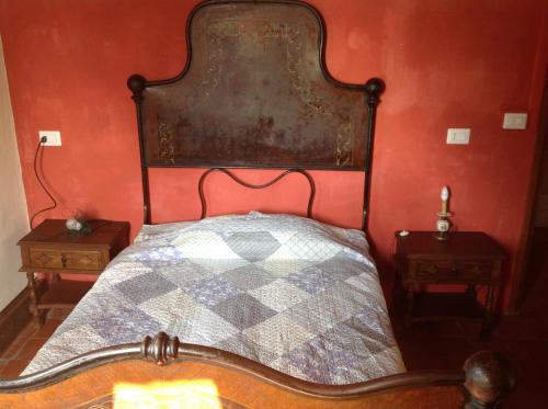 a bedroom with a large bed with red walls at Room and Breakfast Torre in Felino