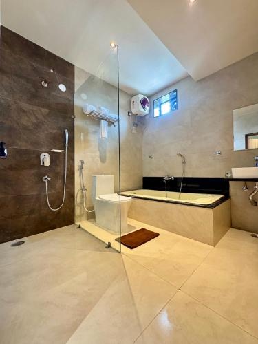 a bathroom with a shower and a sink at Kaysons hotel in Hyderabad