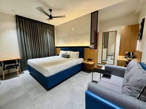 a hotel room with a bed and a couch at Kaysons hotel in Hyderabad