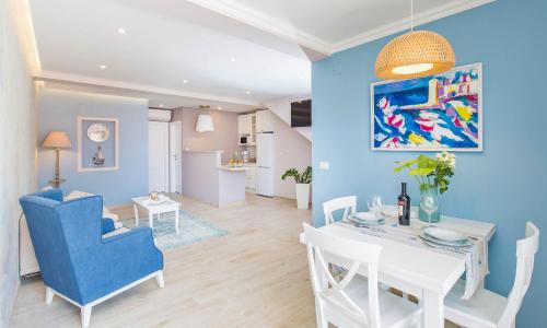 a dining room and living room with a blue wall at Villa Boban in Dubrovnik