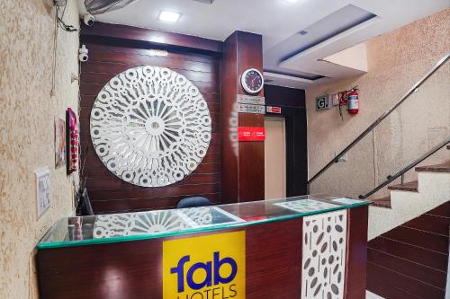 a restaurant with a sign on a wall and a counter at FabHotel Shri Vilas in Bhopal