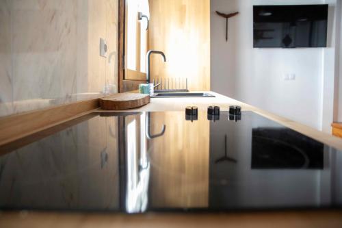 a kitchen with a sink and a counter top at Casa Rural La Rosalia in Cogolludo