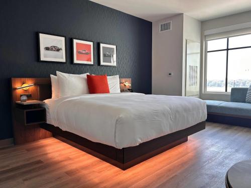 a bedroom with a large bed and a blue wall at Cambria Hotel Northlake Conference Center - Roanoke in Northlake