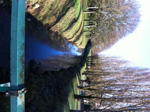 a fence next to a body of water at Les Rêveries in Chazé-sur-Argos