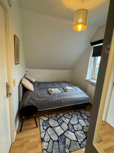 a bedroom with a bed in a small room at Ama Hyg Atelier Copenhagen-NICE TOPFLOOR STUDIO APARTMENT near City & Beach & Metro in Copenhagen