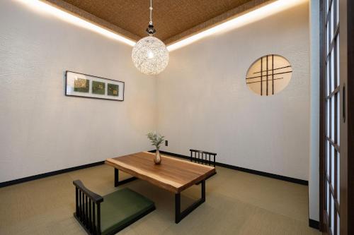 a dining room with a wooden table and chairs at JAPAVISTA Leggero in Osaka