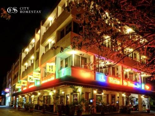 a building with colorful lights on the side of it at City Homestay in Miri