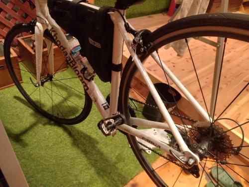 a bike parked in a room with its wheel at EkimaehouseSamaru in Shimanto-cho
