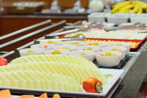 a buffet with many plates of food on a table at ibis Sao Paulo Paulista in Sao Paulo