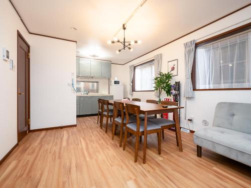 a kitchen and dining room with a table and chairs at Familia Kamata 1 in Tokyo