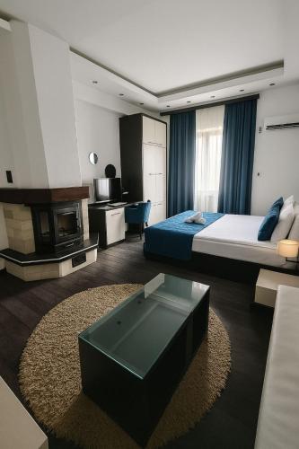 a bedroom with a bed and a living room at Sokoterme Hotel in Soko Banja