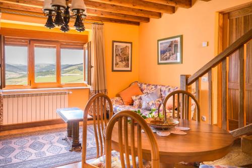 a living room with a table and a couch at Apartamentos Mirador de Bareyo in Bareyo