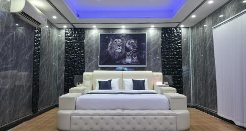 a bedroom with a white bed and a black wall at VENTURA Boutique Residence in Pattaya Central