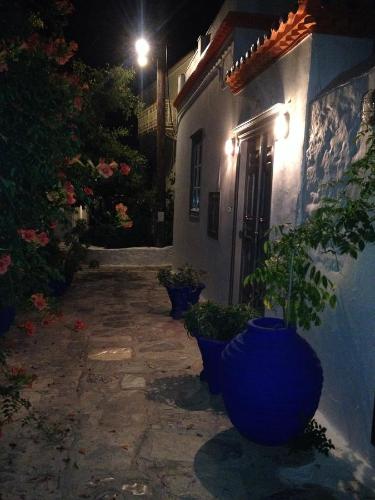 a large blue vase sitting next to a building at night at Manolia in Hydra